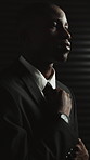 Black man, spy and suit with thinking for secret mission, espionage and danger with insight at office. African person, agent or assassin with undercover assignment, career and hitman with perspective