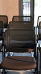 Boardroom, empty and row of chairs for conference, workshop event and seminar. Corporate, furniture and seats in business venue for convention, meeting and presentation in professional office