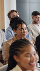 Audience, woman and happy with listening in conference for finance expo, knowledge or agreement. Seminar, crowd or person with smile in hall for financial insight, wealth management or career upskill