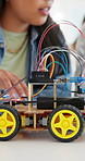 Hands, robotics and discussion in school for students, learning or future development. People, wiring and education with electronics, transportation or machine for knowledge or engineering project