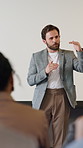 Conference, speech and man with audience for presentation, workshop event or skills training. Meeting, speaker and people in seminar, convention or business coaching for company development in office