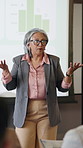 Presentation, discussion and businesswoman in office for training on finance report with statistics. Graphs, talk and mature female financial manager at corporate seminar for investment proposal.