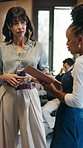 Discussion, notebook and business women in office with research for finance report at conference. Seminar, meeting and female financial advisor with manager for feedback on investment in workplace.