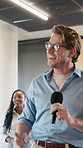 Businessman, team or speaker with microphone for presentation, meeting or staff training in seminar. Man, workshop or talk show with group of employees for open conference, coaching or work tradeshow