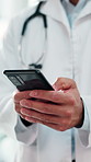 Cellphone, hands and doctor in hospital with telehealth, texting and email for medical feedback. Technology, person and male healthcare worker on phone for online consultation on mobile app in clinic