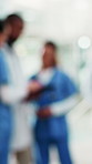 Blur, doctors and nurses with meeting in hospital for education or training of medical students. Conversation, healthcare and planning with staff in clinic for coaching, internship or residency
