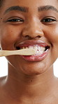 Black woman, face and sustainability with toothbrush in studio, bamboo and recycling on white background. African person, brushing teeth and happy with foam, toothpaste and dental care in Nigeria