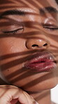 Leaf, shadow and skincare with black woman in studio for organic cosmetics, herbal detox and beauty. Natural treatment, self care and plant facial with person on white background for glow and peace