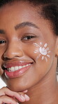 Face, skincare and woman with sunscreen in studio for UV protection, healthy glow and skin benefits. Happy, black girl and SPF cream on white background for moisturizer, self care and beauty routine