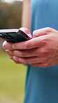 Man, hands and typing outdoor with phone, text message and connectivity for fitness app notification. Person, scroll and browsing with tech for internet, social media and website for wellness tips.