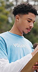 Man, volunteer and reading with clipboard outdoor for food drive, donation inventory and ngo event. Thinking, person or checklist with schedule, social responsibility and information for distribution