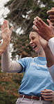 Outdoor, happy women and high five with volunteers, applause and celebration for charity achievement. Park, NGO and people with smile for support, team and clapping with friends for win in nature
