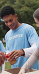 Box, food drive and volunteer group outdoor together for charity, community or donation collection. NGO, packing and service with activist people in park for collaboration, outreach and support