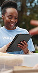 Box, tablet and volunteer group team together for charity, community or donation collection. App, food drive and service schedule with activist people in park for collaboration, outreach and planning