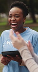 Volunteer, woman and team with applause outdoor for charity success, goal or laugh with tablet. Excited, non profit group or clapping at park for NGO milestone, funny celebration or community service