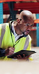 Man, inspection and typing in warehouse with tablet, supply chain or compliance for quality control. Black person, review and check stock in depot with tech, inventory management or logistics report.