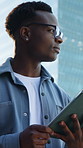 Businessman, online and thinking with tablet in city, walk and research for content creation trends. Serious, social media manager and black person with tech for project, scroll and commute with idea