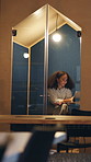 Night, tablet and business woman in cubicle for research, compliance review or reading email. Computer, soundproof booth and consultant in workplace for policy regulation, overtime and privacy