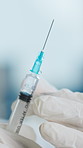 Doctor, needle or injection with liquid drip for cure, vaccination or antibiotic in hospital. Person, hands and syringe with medical fluid for healthcare vaccine, medication or flu shot in clinic