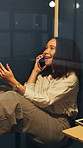Businesswoman, conversation and phone call in office pod with smile, gossip and break for marketing job. Happy, person and relax in cubicle with tech, contact and communication for advertising work.