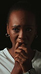 Scared, anxiety and black woman with biting nails in studio, stress and concerned expression for phobia. Fear, worry and person with trauma for emotional distress, nervous habit and dark background