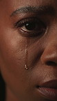 Sad, face and woman with depression, crying and mental health for trauma memories of emotional abuse. Closeup, tears and black person with anxiety, loneliness and despair for tragedy experience.