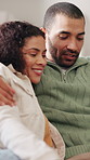 Happy couple, relax and hug on break in lounge, love and romance with partner on couch or affection. Man, laughing and embrace with woman on sofa, resting and bonding with smile on weekend and home