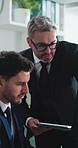 Tablet, meeting and business men in office with feedback, advice or planning on finance report. Technology, discussion and male financial advisor with manager for investment proposal in workplace.