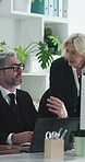 Business people, team and lawyer with laptop at office for discussion, report or insight for legal advice services. Mature man, woman and attorney for planning, feedback or talk at corporate law firm