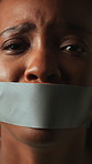 Stress, fear and face of woman with tape for silence, kidnapping and victim of domestic violence. Abuse, black person and mouth cover on studio background for censorship, hostage and panic for danger