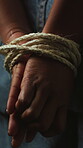 Escape, hands and prisoner with rope in studio, abduction crisis and kidnapped hostage for bondage. Human trafficking crime, victim and person with breakout for freedom, fear and dark background
