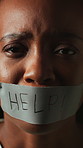 Human trafficking, face or black woman with duct tape, scared or capture in victim awareness. Fear, help sign or female person with sealing strip, hostage crime or danger in exploitation crisis.