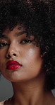 Serious, face and woman with afro, haircare or cosmetic for healthy natural texture, glow and studio. Hair, growth and person with pride for makeup, gray background and beauty with lipstick in Brazil