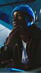 Hacker, man and thinking in basement with computer, cyber attack idea or planning for network breach. Black person, problem solving and desktop with phishing scam, AI and dark web for hacking system.