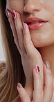 Manicure, makeup and closeup of woman in studio for self care, cosmetics and gel nail polish. Salon, cosmetology and beauty treatment with female person and hands for shine, lipstick and glamour