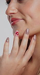 Manicure, makeup and hands with woman in studio for self care, cosmetics and gel nail polish. Salon, cosmetology and beauty treatment with person on white background for shine, lipstick and glamour
