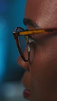 Black woman, night and programmer with glasses in office for software development, app or update. Profile, female person or developer with spectacles for coding, troubleshooting or cybersecurity