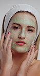 Face, beauty and woman in studio with green mask for facial treatment, skin hydration and wellness. Salon, portrait and person with cosmetics for dermatology, cleanse and skincare on white background