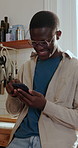 Typing, funny and black man in kitchen, phone for online chatting and app for communication. Home, mobile user and African person with tech for texting, laughing and scroll for entertainment or smile