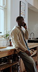 Phone call, discussion and black man in kitchen, network for communication and listening to contact. Mobile user, smile and African person in home, app for online chatting or talking with connection