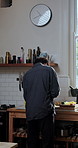 Cooking, back and man in kitchen, cutting vegetables and organic ingredients for healthy food. Salad, breakfast and person in home, culinary skills and recipe for meal prep, wellness and nutrition