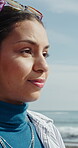 Beach, walking and woman with travel on promenade for holiday adventure, explore nature or fresh air. Vacation, journey and person with stroll at seaside for weekend break, sightseeing and getaway