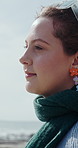 Travel, thinking and woman with view of beach for holiday getaway, nature appreciation or fresh air. Vacation, reflection and person with sightseeing on promenade for weekend break, explore and trip