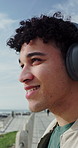 Outdoor, relax and man by beach with headphones for online meditation, podcast or music for peace. Calm, breathing and male person with audio tech for listening to playlist or album on promenade.