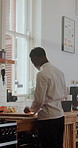 Chef, cooking and black man with vegetables in kitchen at restaurant for meal prep, cuisine and recipe. Hospitality, catering and person with carrots for dinner, lunch and food for culinary business