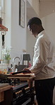 Chef, cutting and black man with vegetables in kitchen at restaurant for meal prep, cuisine and recipe. Cooking, catering and person with carrots for dinner, lunch and food for culinary business