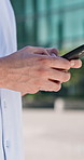 Typing, phone and hands of man in city for social media, networking and email on work break. Business, chat and person on cellphone for internet, notification and communication on mobile app in town