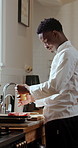 Cooking, seasoning and chef with meat in kitchen at restaurant for meal prep, cuisine and recipe. Food, catering and black man with steak, ingredients and spices for dinner, lunch and culinary skills