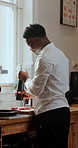 Cooking, pepper and chef with meat in kitchen at restaurant for meal prep, cuisine and recipe. Hospitality, catering and black man with seasoning for steak dinner, lunch or food for culinary business
