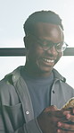 Phone, happy and black man in office with texting, networking or communication on mobile app. Typing, lens flare and African male person with cellphone for online email with contact in workplace.